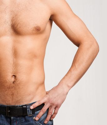 shirtless man in jeans