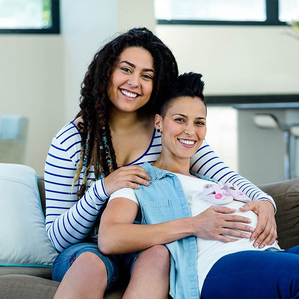 Pregnant lesbian couple sitting together