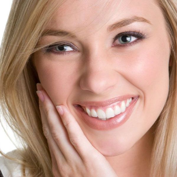 Woman smiling resting her head in her hand