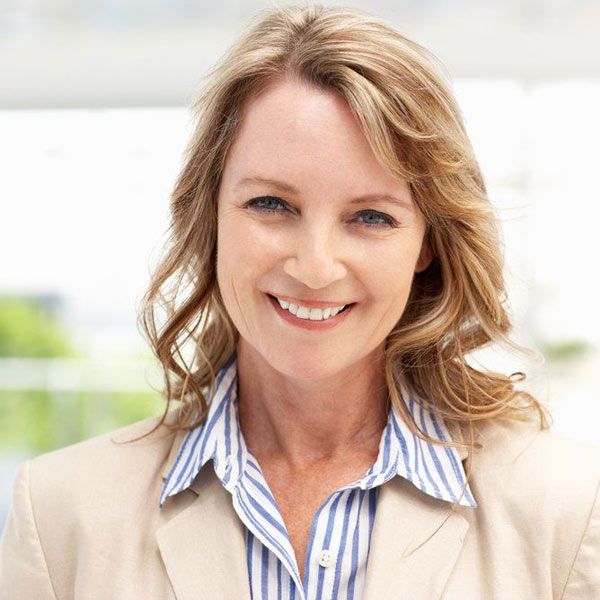 Woman smiling after receiving endodontic treatment