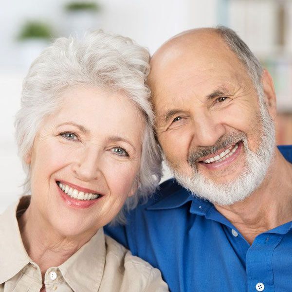 Couple smiling after having received inlays