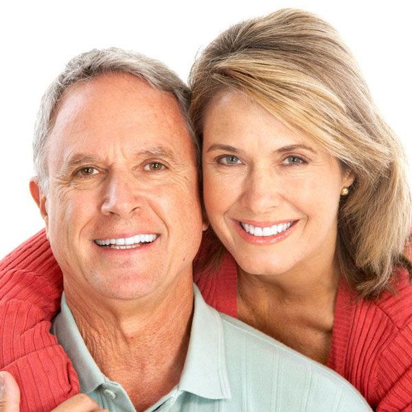 couple smiling after experiencing relief from a mouth guard