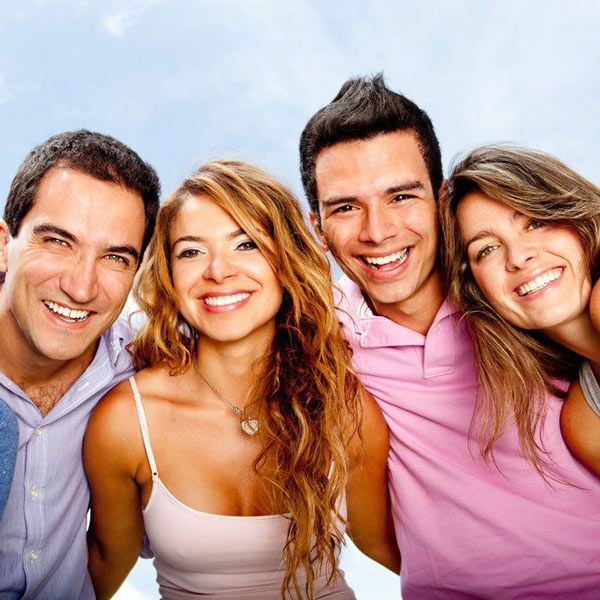 A group of friends huddled together and smiling