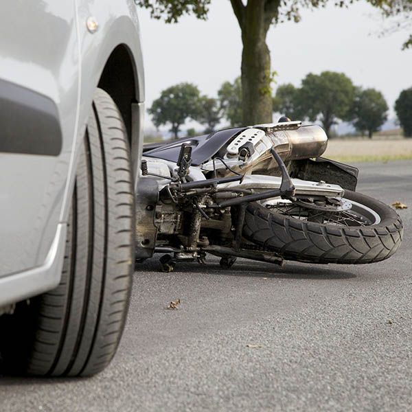Motorcyclist leaning against bike