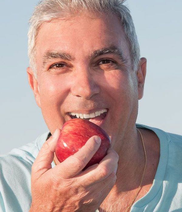 Man biting into apple