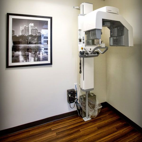 Cosmetic Dentist: Photo showing a dental examination chair from the back in front of a cityscape.