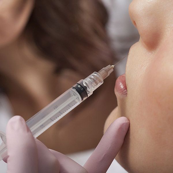 Woman receiving injectable in lips