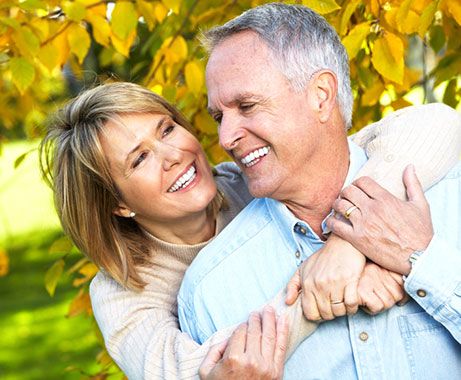 Happy couple with white teeth enjoying the outdoors.