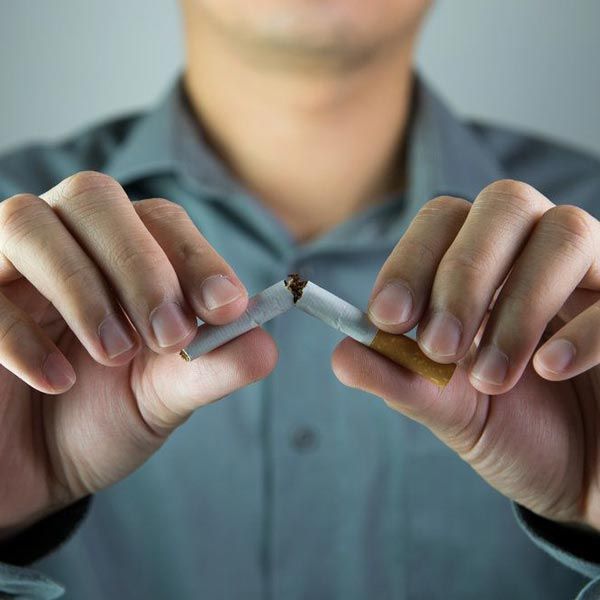 Man breaking cigarette