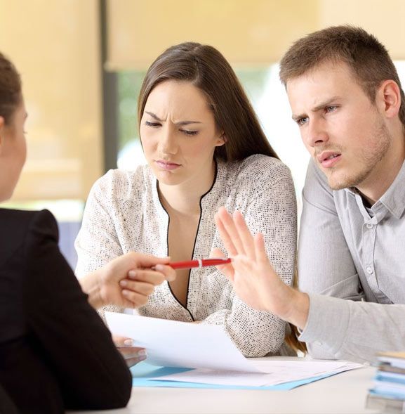 couple speaking to insurance adjuster