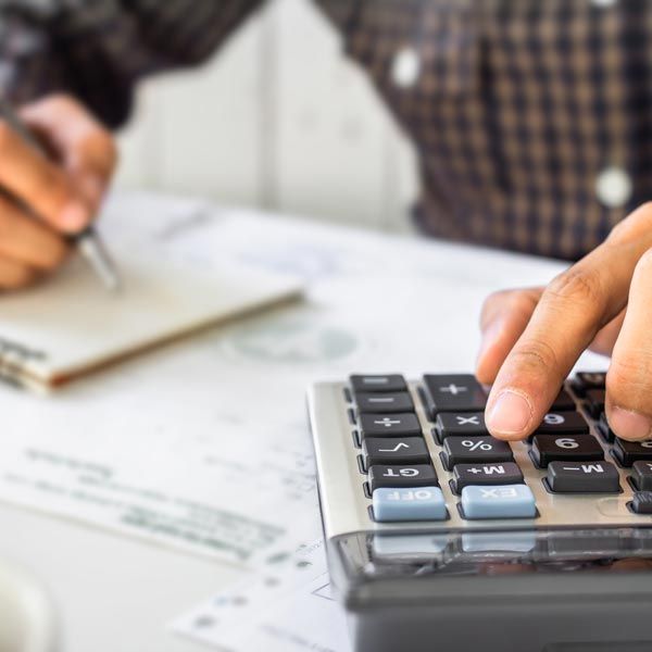 Man using calculator to complete paperwork