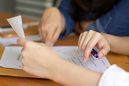 Doctor writing on notepad at his desk