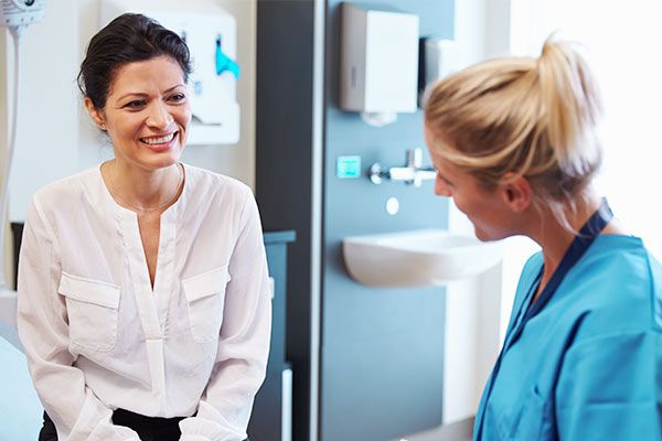 Woman speaking to doctor at office
