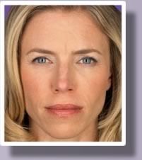 A blonde woman with a less noticeable wrinkle between her eyebrows.