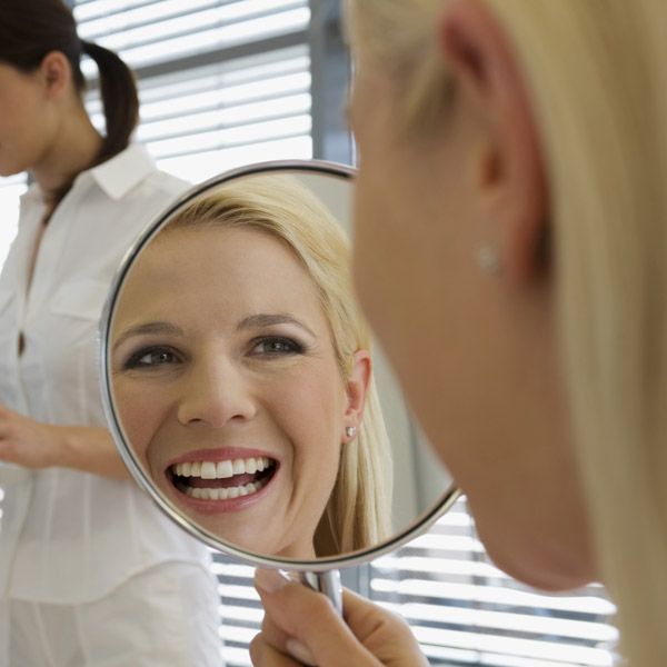 woman smiling in the mirror