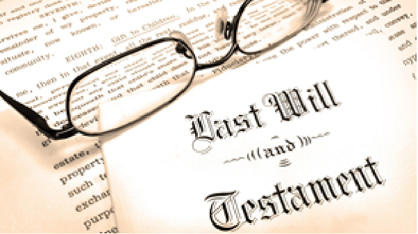 Pair of eyeglasses on top of Last Will and Testament documents
