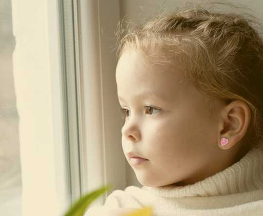 child looking out of a window