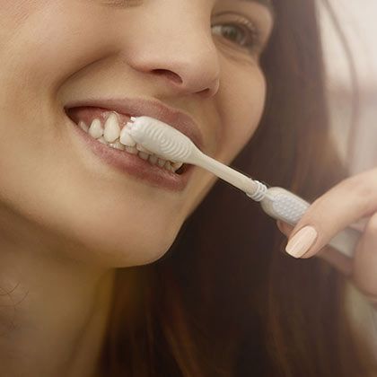 Woman brushing teeth
