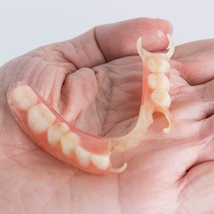 Denture in palm
