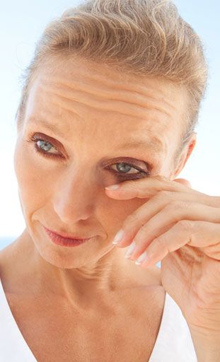 woman touching eye
