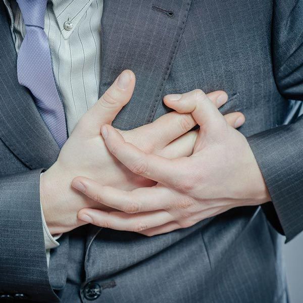 Person holding hands to chest