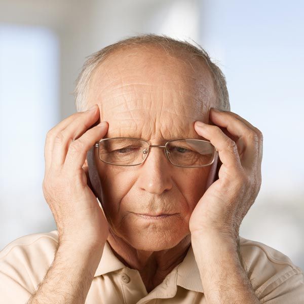 Man holding hands to his head