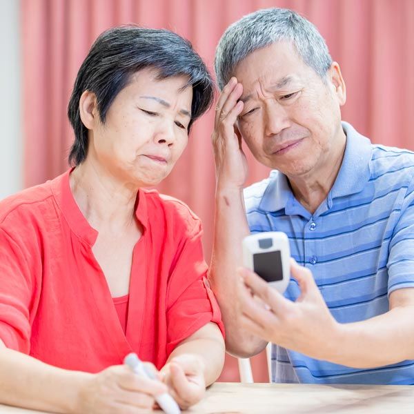Couple looking at output of glucose monitor