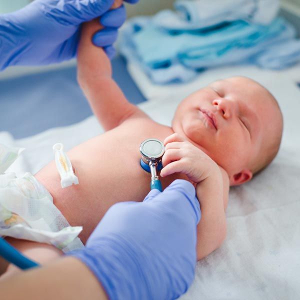 Doctor listening to an infant's heartbeat