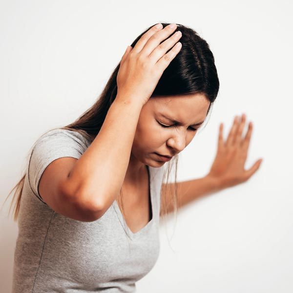 Dizzy woman holding head