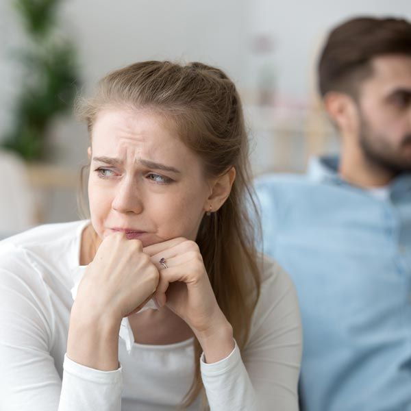 Woman crying next to man