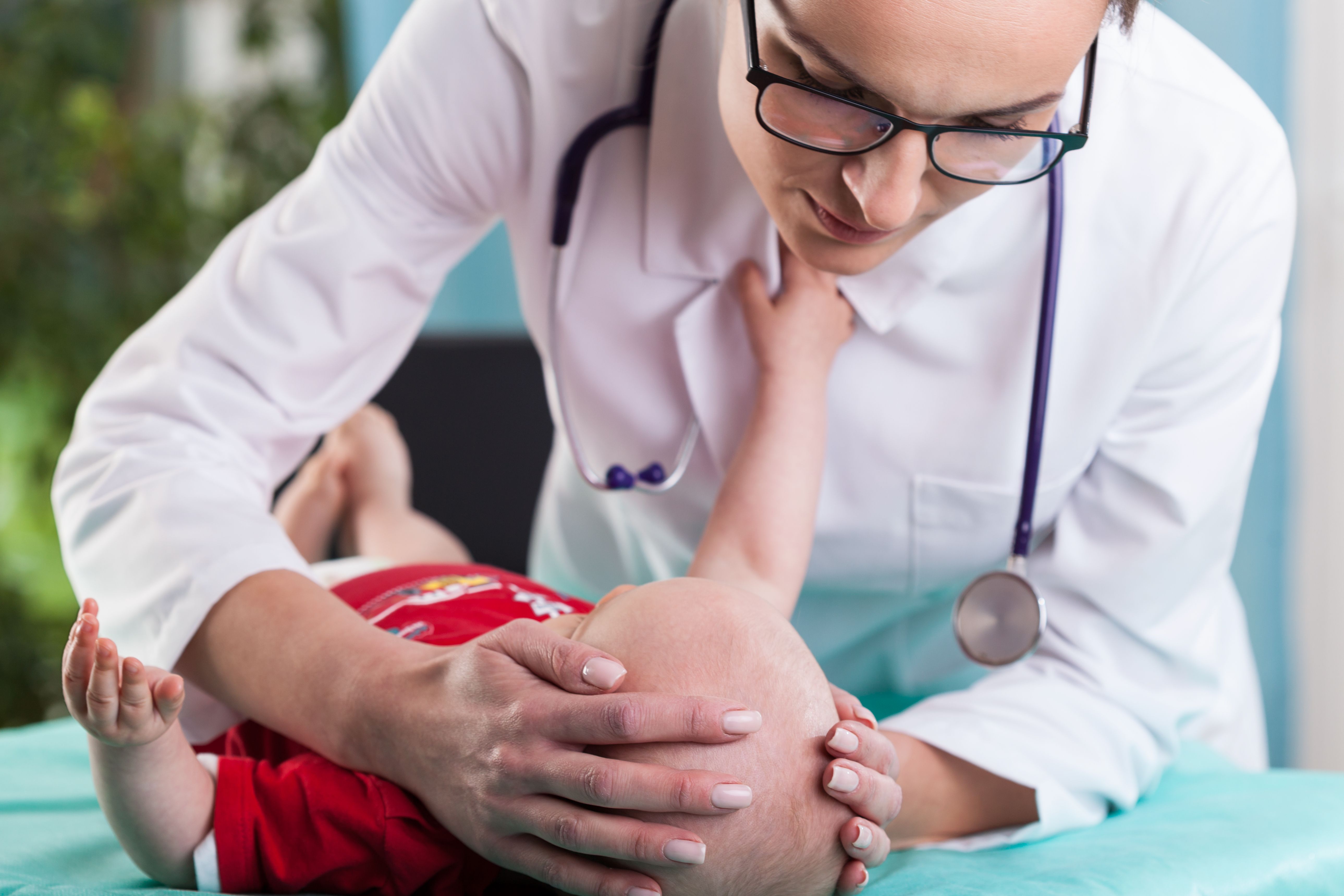 Woman examining baby
