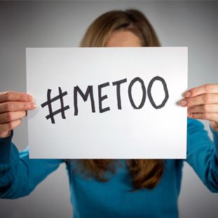 Woman holding #metoo sign blocking her face