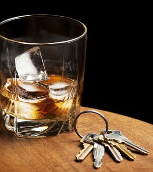 Photo of keys next to a drink