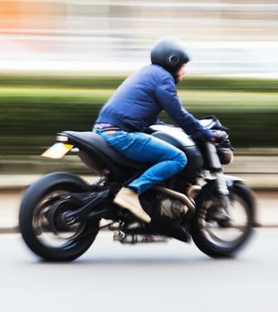 Blurred photo of a motorcycle rider