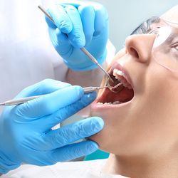 Dental patient undergoing scaling and root planing
