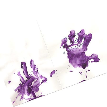 Greeting card covered in purple finger paint