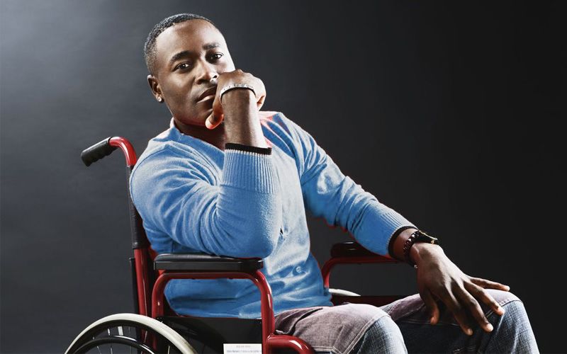 An African American man ponders his new life in a wheel chair after a spinal cord injury