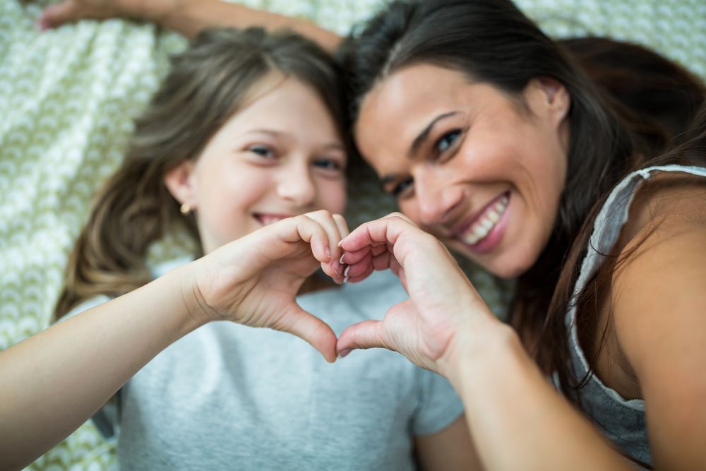 Woman playing with young daughter