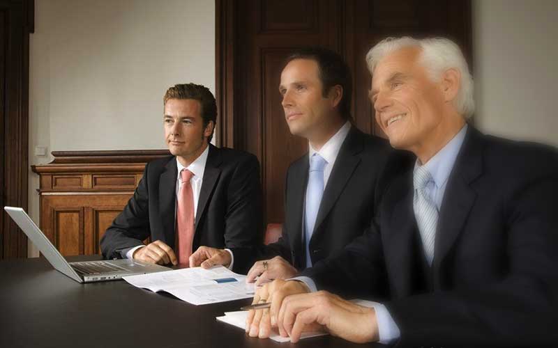 Men in suits at table