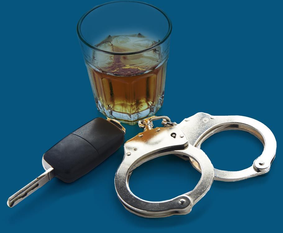 Glass of alcohol next to car keys