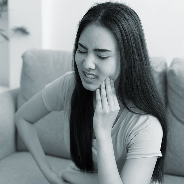 A woman experiencing tooth pain