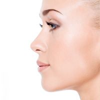 Una mujer hermosa con la piel pálida en una foto de perfil que mira hacia la izquierda.