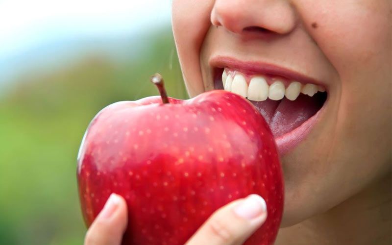 woman bites apple