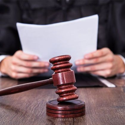 Closeup on gavel in front of judge