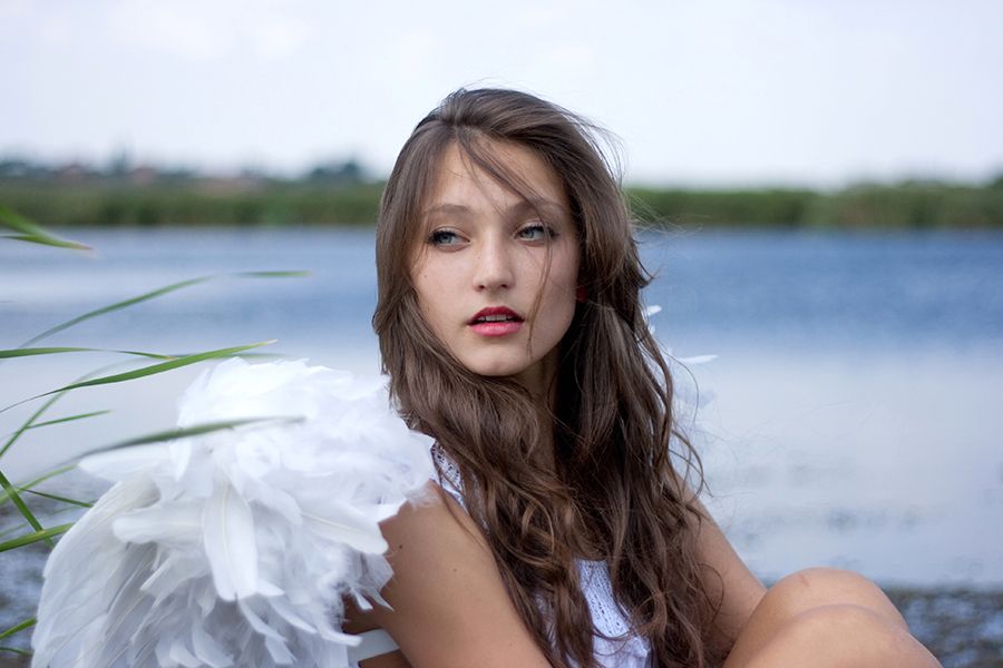 A woman with angel wings by the lake