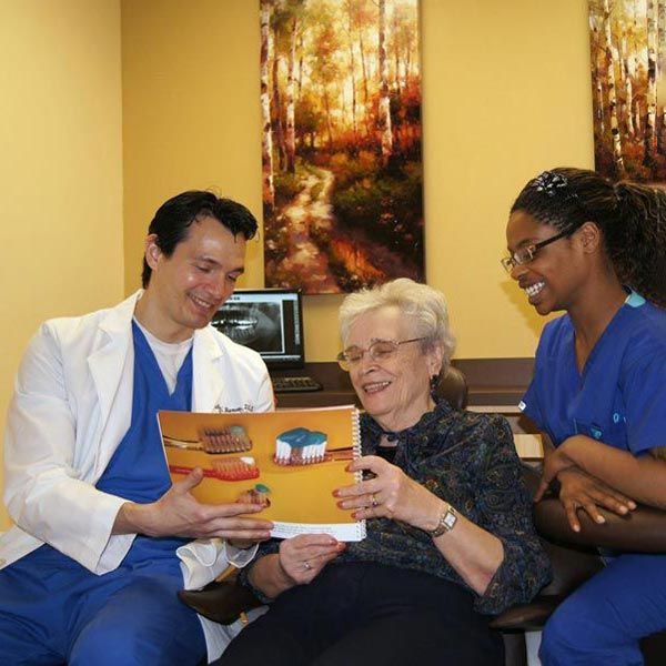 Doctor holding up informational booklet for patient