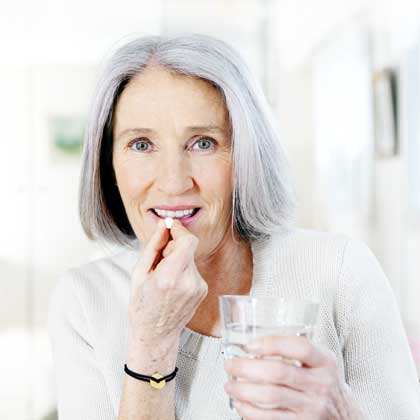 woman taking a pill